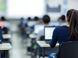A classroom with classmates on laptops learning.