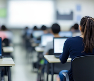 A classroom with classmates on laptops learning.